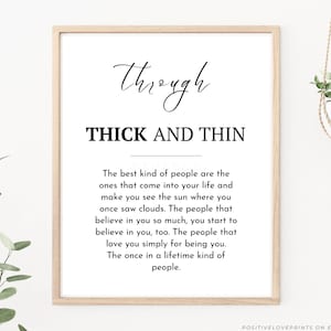 May include: A framed print with the words "through" in cursive above "THICK AND THIN" in bold, black letters. Below, a paragraph describes the best kind of people. The print is in a light wood frame, with a white background. The bottom right corner has the text "POSITIVELOVEPRINTS ON ETSY".
