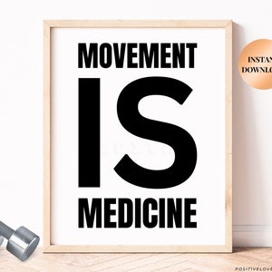 May include: Black and white printable wall art with the text "Movement is Medicine" in a bold, modern font. The print is framed in a light wood frame and is ready to be downloaded.