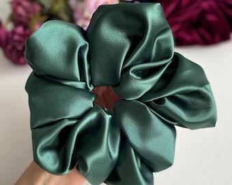 May include: A dark green satin scrunchie for hair.