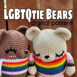 May include: Two crocheted amigurumi bears with rainbow stripes. The bears are brown and beige and have black eyes and noses. The text "LGBTQtie Bears digital pattern" is above the bears.