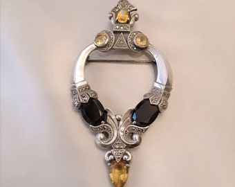 Very pretty baroque brooch, in silver, onyx, citrine, decorated with marcasites, circa 1950.