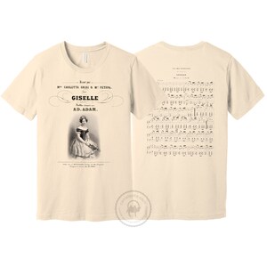 May include: A beige t-shirt with a vintage image of a ballerina on the front and sheet music for the ballet "Giselle" on the back. The text on the front reads "Mme. Carlotta Grisi & M. Petipa. Giselle. Ballet compose par A.D. Adam."