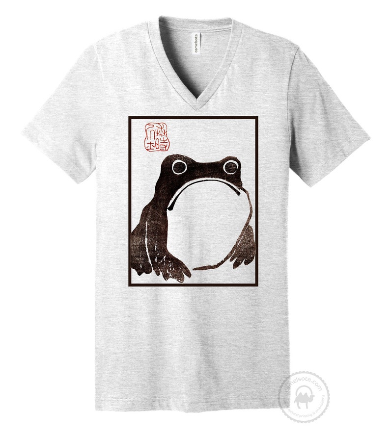 May include: A gray V-neck t-shirt with a black and white image of a frog in a square frame. The image is a Japanese woodblock print with a red seal in the upper left corner.