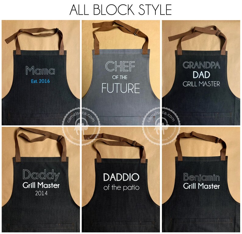K&ouml;nnte beinhalten: Sechs verschiedene Sch&uuml;rzen mit unterschiedlichen Texten. Die Sch&uuml;rzen sind schwarz und grau mit braunen Tr&auml;gern. Der Text auf den Sch&uuml;rzen lautet "Mama Est. 2016", "Chef of the Future", "Grandpa Dad Grill Master", "Daddy Grill Master 2014", "Daddio of the Patio" und "Benjamin Grill Master".
