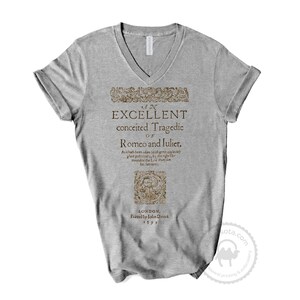 May include: A gray V-neck t-shirt with a vintage-style print of the title page of "An Excellent Conceited Tragedie of Romeo and Juliet" printed in brown. The text includes the play's title, author, publisher, and publication date: 1599.