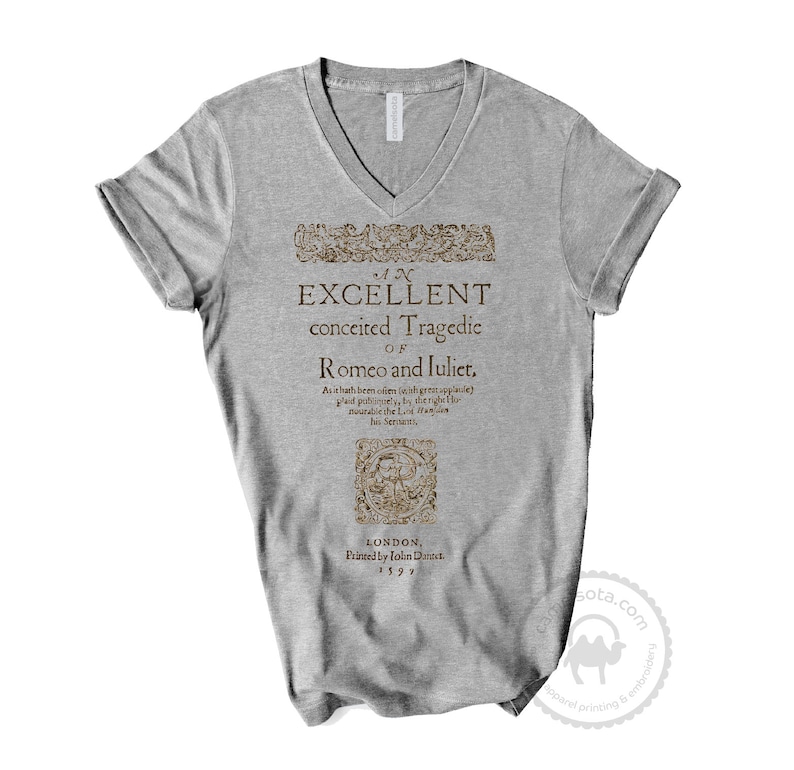 May include: A gray V-neck t-shirt with a vintage-style print of the title page of "An Excellent Conceited Tragedie of Romeo and Juliet" printed in brown. The text includes the play's title, author, publisher, and publication date: 1599.