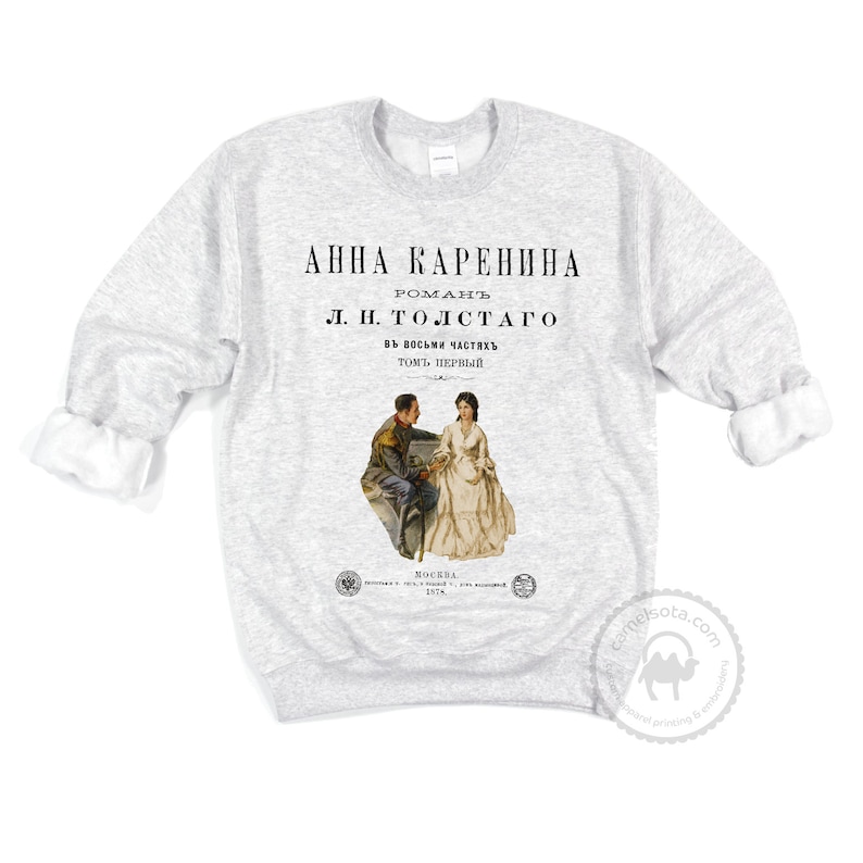 May include: A gray sweatshirt with a vintage book cover design featuring the title "Anna Karenina" by L.N. Tolstoy. The cover art depicts a man and woman in 19th-century attire.
