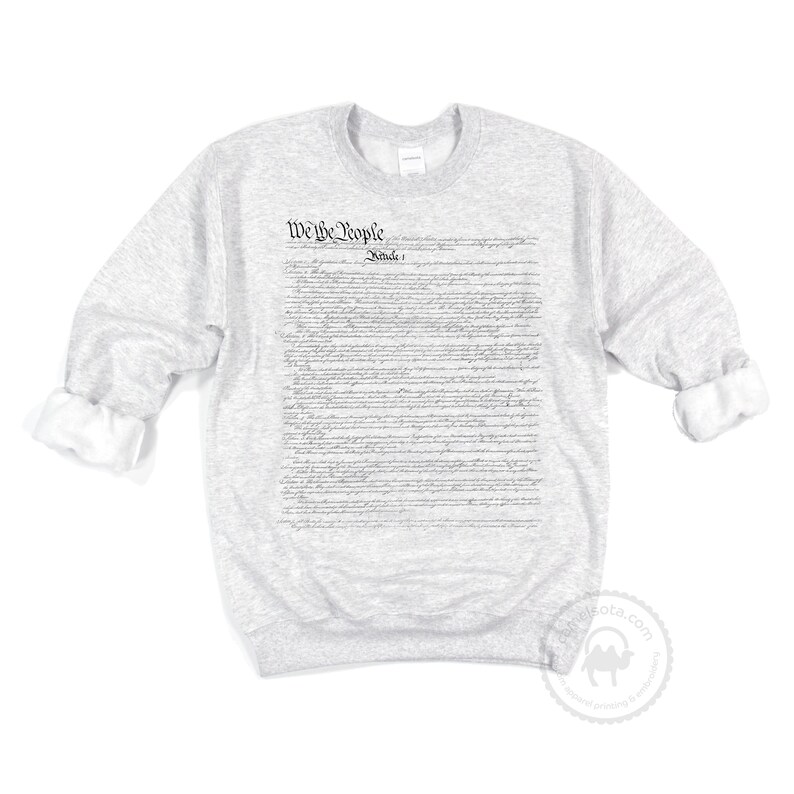 May include: A grey sweatshirt with the full text of the US Constitution printed on the front. The text includes the phrase "We the People" and "Article I".