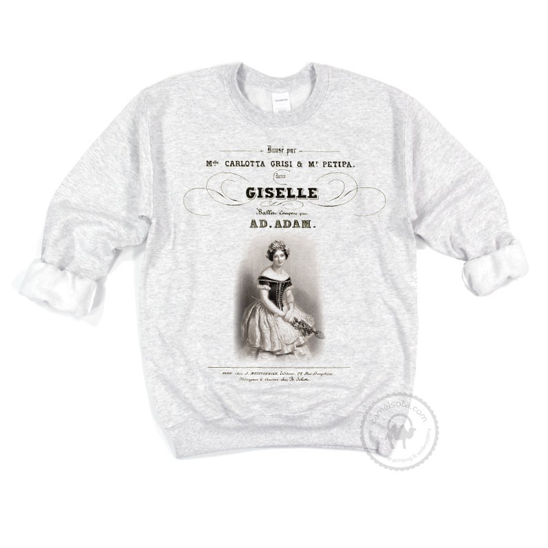 May include: A gray sweatshirt with a vintage-style print of a ballerina in a white dress. The print includes the text "Banse par M CARLOTTA GRISI & &Mu;&Epsilon; &Rho;&Epsilon;&Tau;&Iota;&Rho;&Alpha;. GISELLE Ballet Compos&eacute; par AD.ADAM."