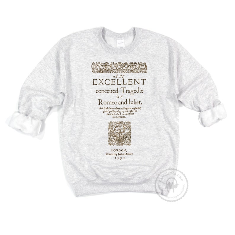 May include: A gray sweatshirt with a vintage-style print of the title page of a play. The title reads "An Excellent Conceited Tragedie of Romco and luliet." The text is in a brown font and is surrounded by a decorative border. The text also includes the date "1597" and the location "London, Printed by John Direct."