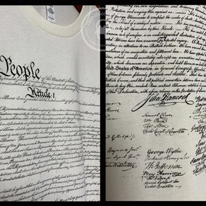 May include: A white t-shirt with the full text of the United States Constitution printed on it. The text is in black ink and includes the signatures of the founding fathers. The shirt is a great way to show your patriotism and love of American history.
