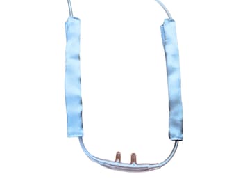May include: A clear plastic medical tubing with two blue fabric covers. The tubing has a Y-shaped connector at the bottom.