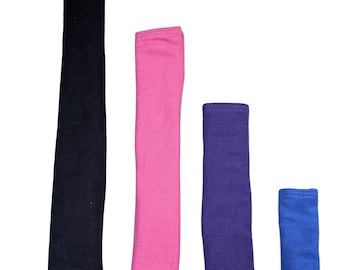May include: Four fabric wrist cuffs in different colors and sizes. The cuffs are black, pink, purple, and blue.