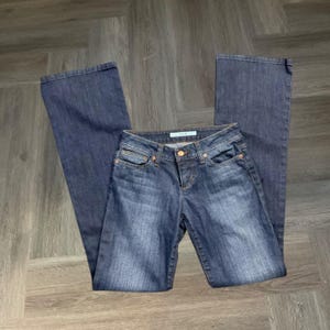 May include: A trio of ceramic mugs with a speckled, matte finish in cream, light grey, and dark grey. Each mug features a simple, minimalist design, ideal for tea or coffee.