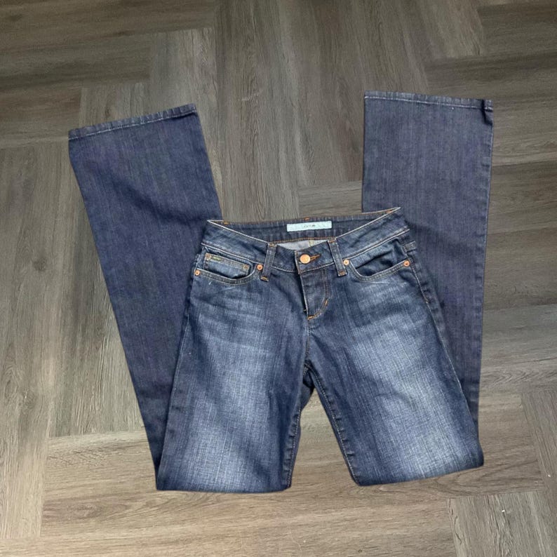 May include: A trio of ceramic mugs with a speckled, matte finish in cream, light grey, and dark grey. Each mug features a simple, minimalist design, ideal for tea or coffee.