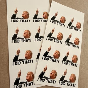 May include: Sheets of white stickers featuring a cartoon image of a man pointing upwards with the text "I DID THAT!" in black. The stickers are arranged in rows and columns on the sheets.