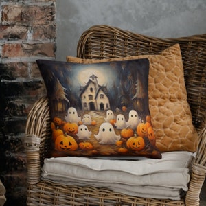 May include: A decorative throw pillow with a Halloween theme. The pillow features a dark forest scene with a spooky house, pumpkins, and ghosts.
