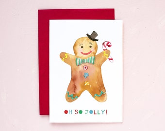 May include: Watercolor Christmas card featuring a gingerbread man with a black top hat, green and white striped bow tie, and a candy cane. The card has the text "OH SO JOLLY!" in colorful letters and is paired with a red envelope.