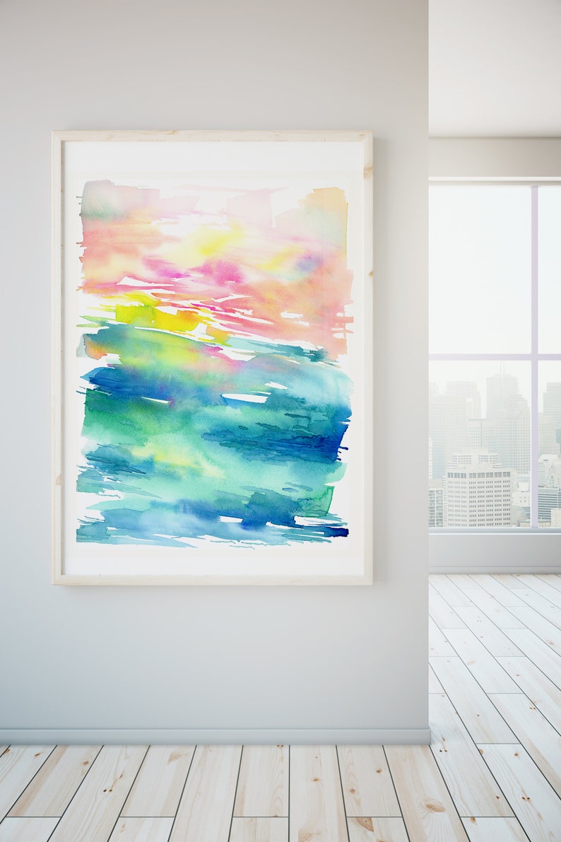 K&ouml;nnte beinhalten: Abstraktes Aquarellbild in einem Holzrahmen. Das Bild zeigt eine Mischung aus rosa, gelben, gr&uuml;nen und blauen Farbt&ouml;nen, die einen geschichteten und strukturierten Effekt erzeugen.