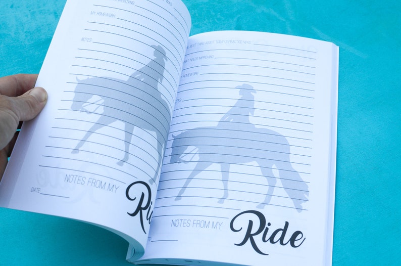 May include: Open notebook with lined pages and a silhouette of a person riding a horse. The notebook has the words "Notes from my Ride" written on the bottom of the page.