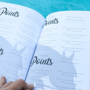 May include: An open notebook with a horse silhouette on the cover. The pages are filled with lines for tracking points, dates, locations, and classes.