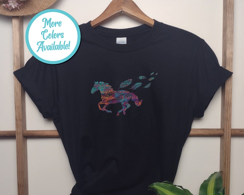 Peut inclure: T-shirt noir avec une silhouette de cheval color&eacute;e et des plumes. Le cheval est compos&eacute; de plusieurs couleurs, dont le rouge, l'orange, le jaune, le vert, le bleu et le violet.