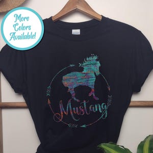 May include: Black t-shirt with a colorful graphic of a horse and the word "Mustang" printed on it.