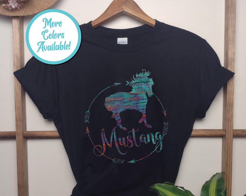 May include: Black t-shirt with a colorful graphic of a horse and the word "Mustang" printed on it.