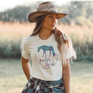 May include: White t-shirt with a colorful graphic of a horse and the text "Quarter Horse" in a circle with arrows.