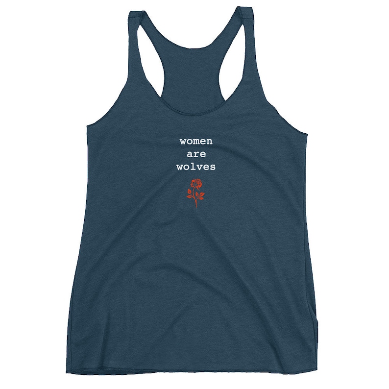 May include: A dark blue racerback tank top with the text "women are wolves" in white and a red rose graphic.
