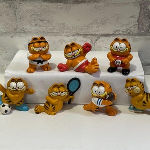 Garfield Plastic PVC figure Fat Cat Kitten Lasagna Cartoon 1980s Comic Jim Davis Smug Attitude Golfer Wrestler Sports Tennis Wrestler Skiing