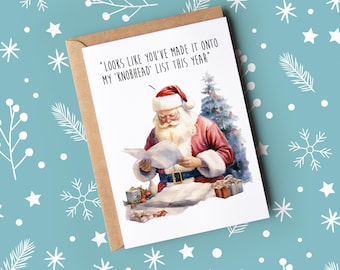 May include: A humorous Christmas card featuring a cartoon Santa Claus reading a list with the text "LOOKS LIKE YOU'VE MADE IT ONTO MY 'KNOBHEAD' LIST THIS YEAR".