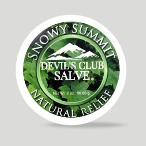 May include: A round container with the text "SNOWY SUMMIT DEVIL'S CLUB SALVE NATURAL RELIEF." The label features a mountain graphic and green leaf design. Net weight is 2 oz (56.69 g).