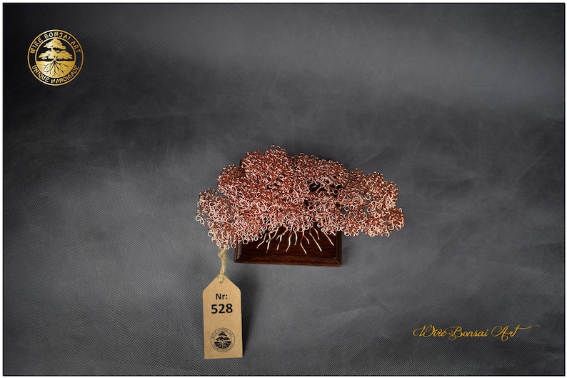 May include: A copper wire bonsai tree sculpture on a wooden base. The tree is in a cloud-like shape with many branches. The sculpture is tagged with a number "528".