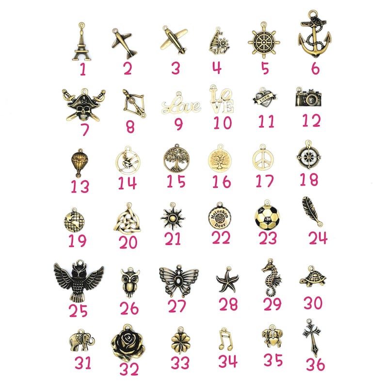 May include: A collection of antique gold-colored charms, each with a unique design. The charms include an Eiffel Tower, airplanes, a pirate skull, a camera, a compass, and various other symbols. These charms are ideal for jewelry making.