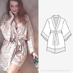 Könnte beinhalten: Eine beige Seidenrobe mit einem schwarzen abstrakten Gesichtsdruck und einem passenden Bindegürtel. Die Robe hat lange Ärmel und einen Schalkragen. Rechts im Bild ist eine Strichzeichnung einer Robe zu sehen.