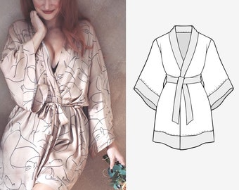 Könnte beinhalten: Eine beige Seidenrobe mit einem schwarzen abstrakten Gesichtsdruck und einem passenden Bindegürtel. Die Robe hat lange Ärmel und einen Schalkragen. Rechts im Bild ist eine Strichzeichnung einer Robe zu sehen.