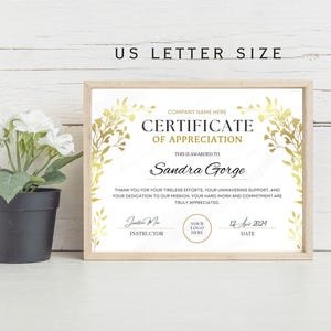 May include: A white certificate of appreciation with gold floral accents. The certificate is framed and reads "Certificate of Appreciation" and "This is awarded to Sandra Gorge".
