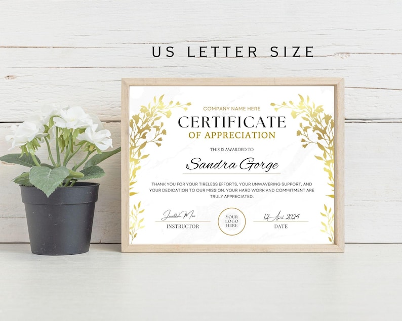 May include: A white certificate of appreciation with gold floral accents. The certificate is framed and reads "Certificate of Appreciation" and "This is awarded to Sandra Gorge".