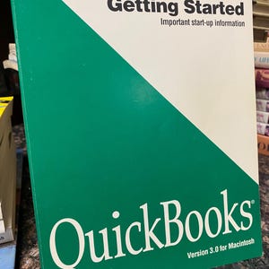 May include: A green and white QuickBooks Version 3.0 for Macintosh manual. The cover features the text "Getting Started" and "Important start-up information". The QuickBooks logo is prominently displayed.