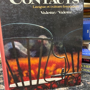 May include: A textbook titled "Contacts" with the text "Langue et culture français" and "Valette/Valette." The cover is dark with a stylized image of a chair and a fiery background. The book is a fourth edition.