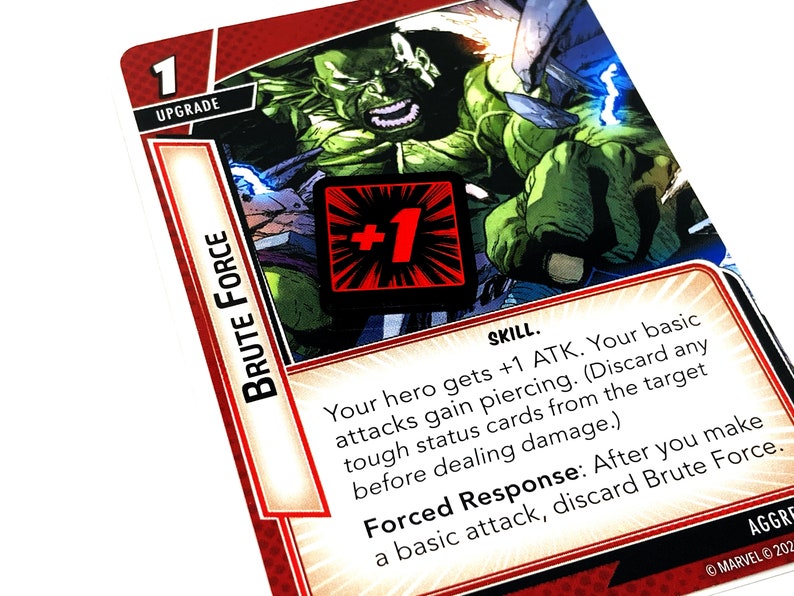 May include: A green and red card with the text "BRUTE FORCE" and "SKILL." The card features a green character with a red +1 symbol. The text reads: "Your hero gets +1 ATK. Your basic attacks gain piercing. (Discard any tough status cards from the target before dealing damage.) Forced Response: After you make a basic attack, discard Brute Force."