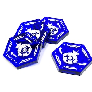 May include: Four blue hexagonal game tokens with white spaceship designs and arrows. The tokens are made of acrylic and have a glossy finish.