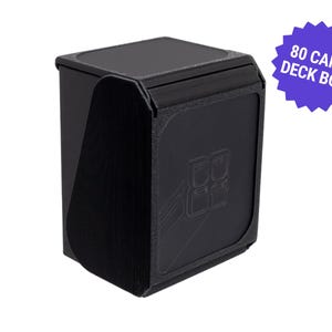 May include: A black card deck box with a lid, designed to hold 80 cards. The box has a textured surface and a graphic design on the front. A purple starburst graphic on the right says "80 CARD DECK BOX".