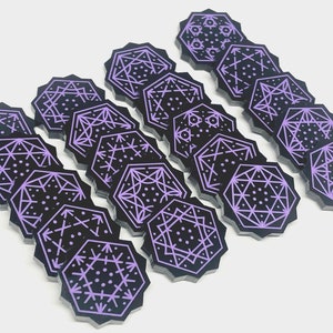 May include: A set of 15 purple and black octagonal game pieces with geometric designs. Each piece features a different pattern.