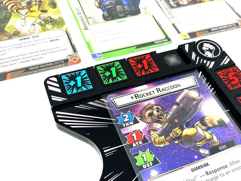 May include: A black and white character card for the Rocket Raccoon character from the Marvel universe. The card has a picture of Rocket Raccoon holding a gun and a purple background. The card has a 2 for THW, 1 for ATK, and 1 for DEF. The card also has a +1, +1, +1, and +5 token on the card.