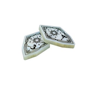 May include: Two white, shield-shaped game pieces with black designs. One piece has a sun and the number "3" on it. The other piece has a sun and a symbol that looks like an axe.
