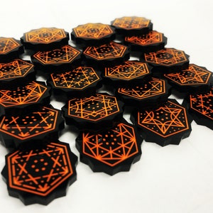 May include: A set of 15 black octagonal game pieces with orange geometric designs. The pieces are arranged in a staggered pattern.