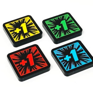 May include: Four square game pieces with black borders and a white starburst design. Each piece has a different coloured background: yellow, green, red, and blue. The centre of each piece has a white " +1" printed on it.