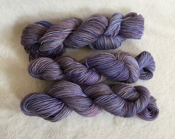 May include: Three skeins of purple and grey yarn, twisted together.